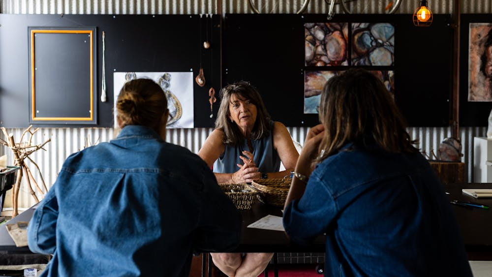 three people talking at a table