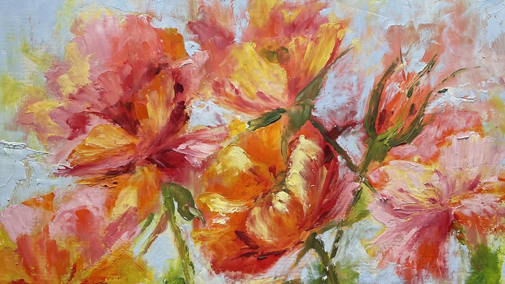 Colourful flowers in red orange pink and green on a pale background