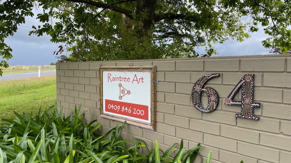 Sign and street number out the front of the gallery