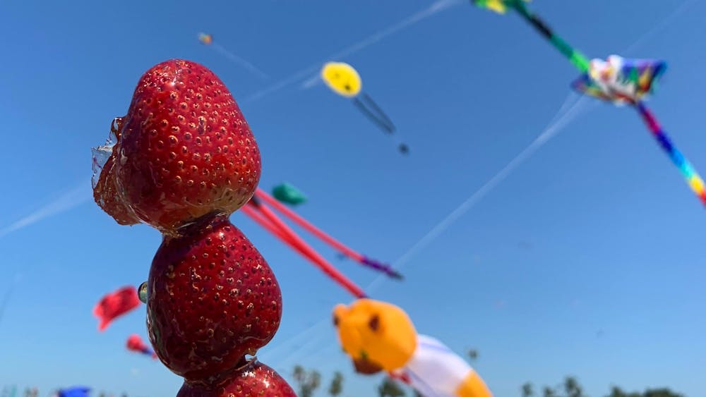 Tanghulu with kites being flown in the background