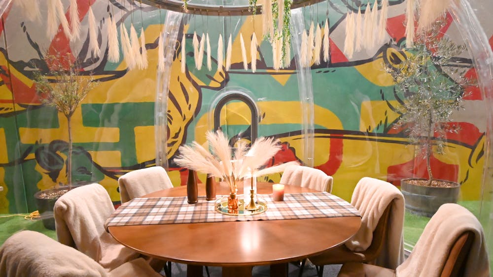 Cosy winter igloo with dining chairs and table and throw rugs