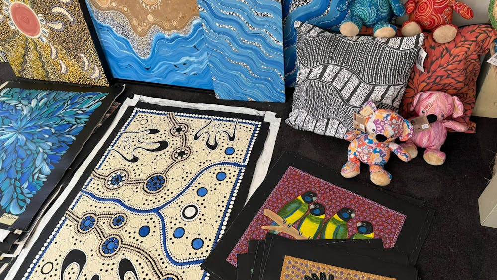 several bright paintings and stuffed koalas