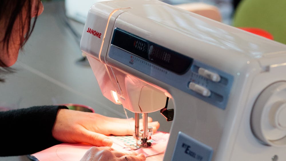 a person operating a sewing machine