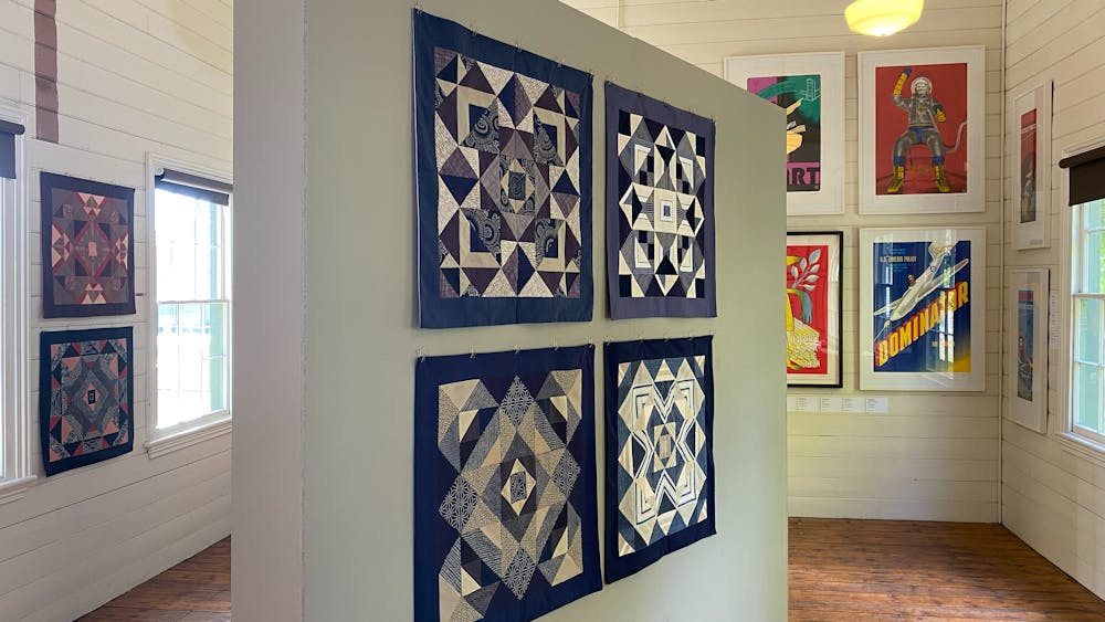 Gallery interior with artworks on freestanding wall, timber floors and shiplap walls, Clunes.