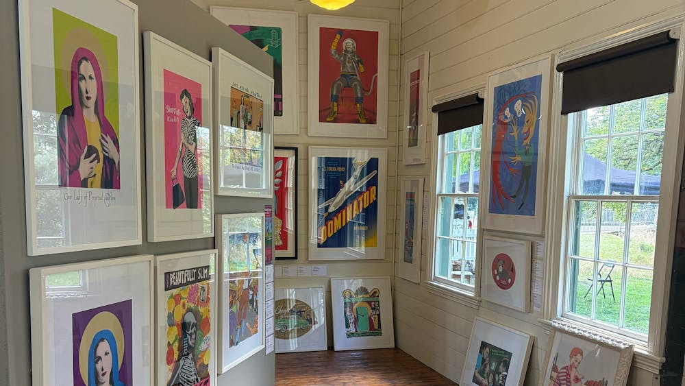 Colourful framed screenprints covering the walls of a timber heritage gallery interior, Clunes.