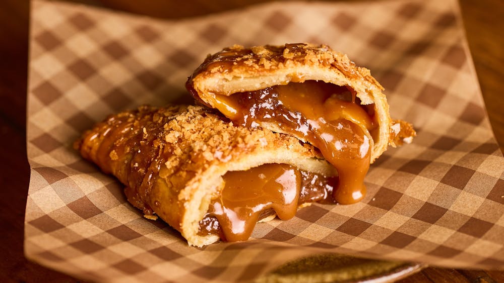 A cut open pie with filling oozing out