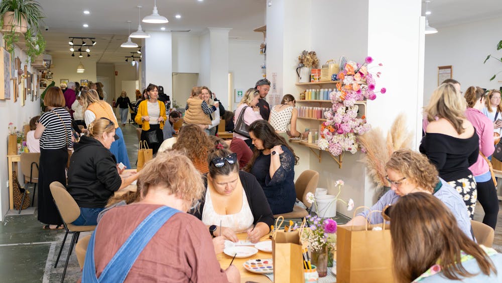Customers painting in our paint your own pottery workshop space.