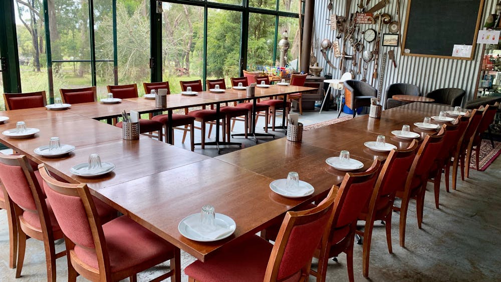 tables set up in a U shaped pattern to  suit a conference
