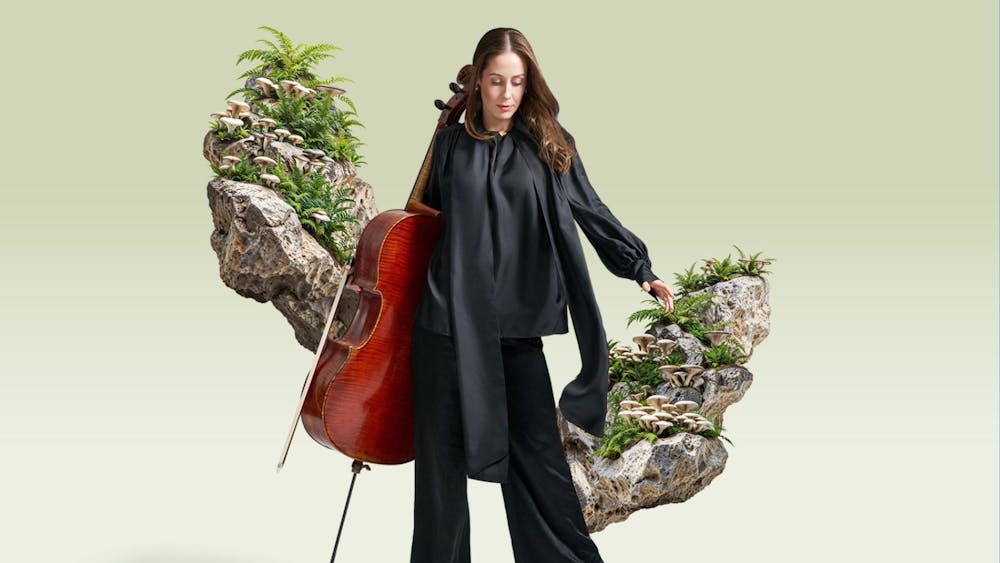 A woman with a cello in front of a surreal bonsai garden that floats