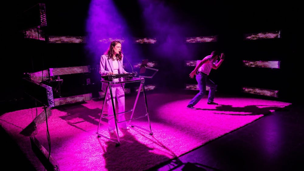 Karin McCracken singing on the synths while Simon Leary dances