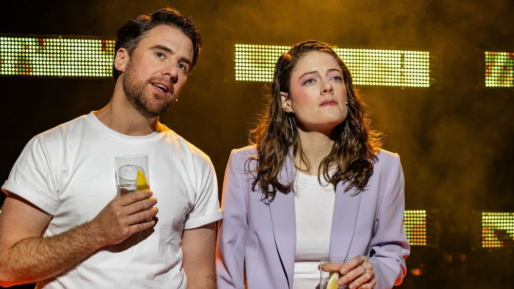 Simon Leary and Karin McCracken sharing a beer, Karin does not look happy