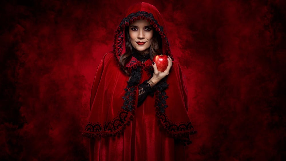 Red Riding Hood holding a poisoned apple