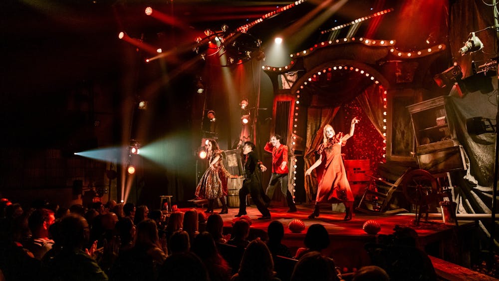 The full cast on stage with their huge theatrical set dressing