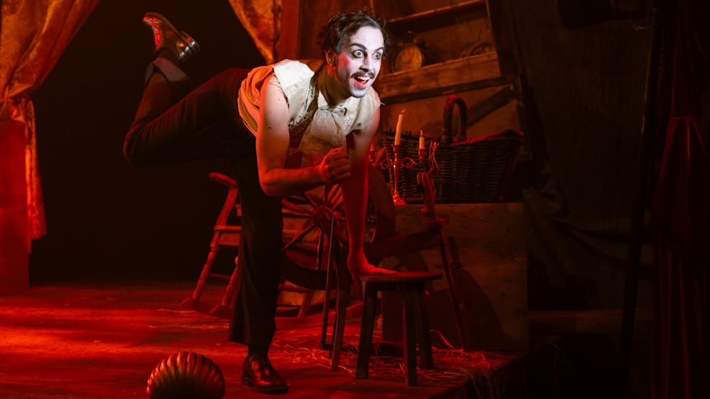 The narrator in the spotlight, looking wild-eyed and intense