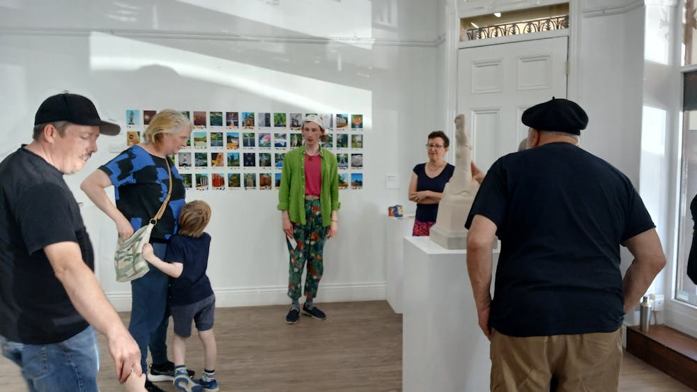 Members of the community viewing artworks installed in the gallery