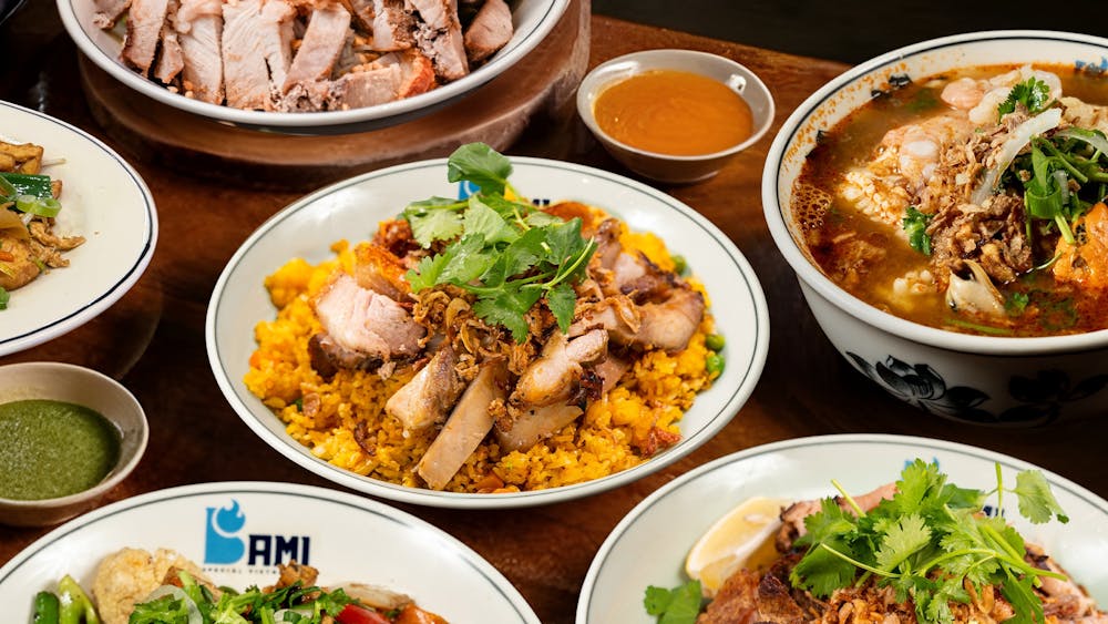 Bami Vietnamese food spread featuring crackling roast pork, smoky fried rice, Noodles and more