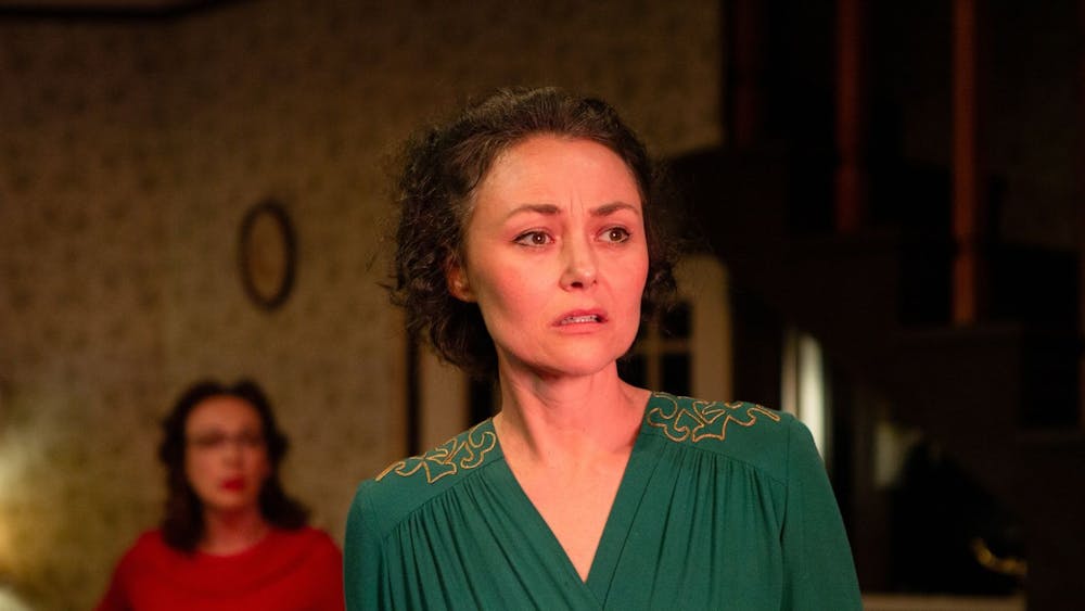 Nancy (Ngaire Dawn Fair) staring off and looking pensive with Nancy (Emily Goddard) behind her