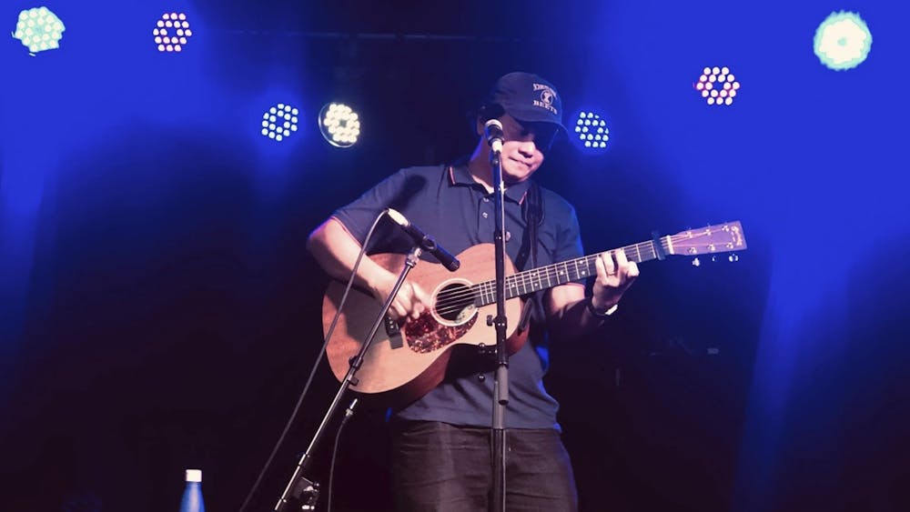 Image shows Karlo Arcinue playing guitar