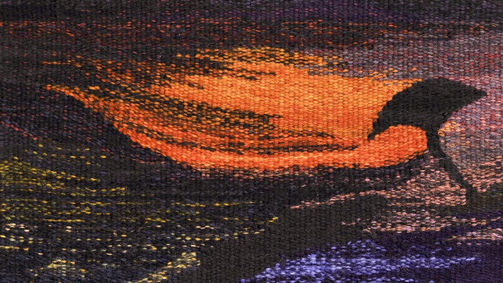 woven tapestry with reddsh golden scene