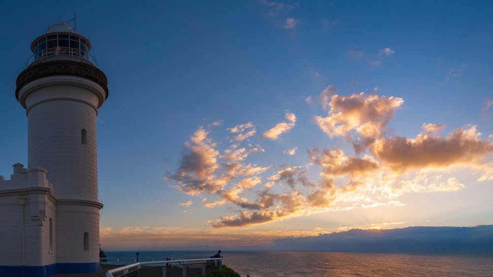 Golden Sunrise with clouds over the sea and lighthouse