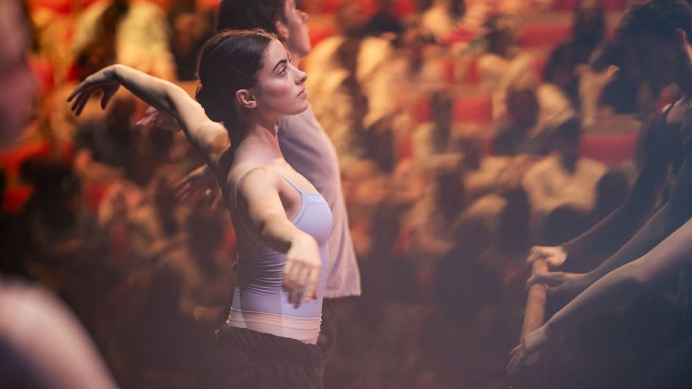 Male and female ballet dancers rehearsing on stage
