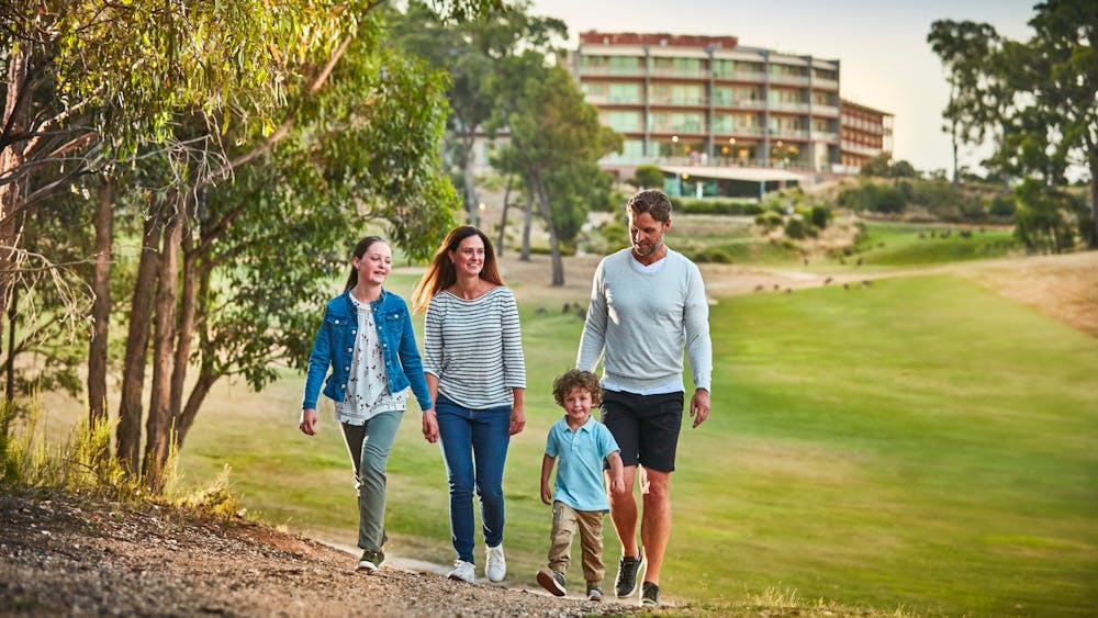 Happy family walking along track