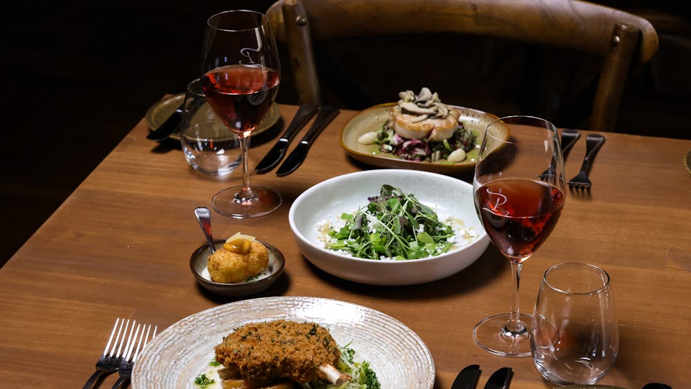 Dishes served with wine glasses at Peasant Osteria