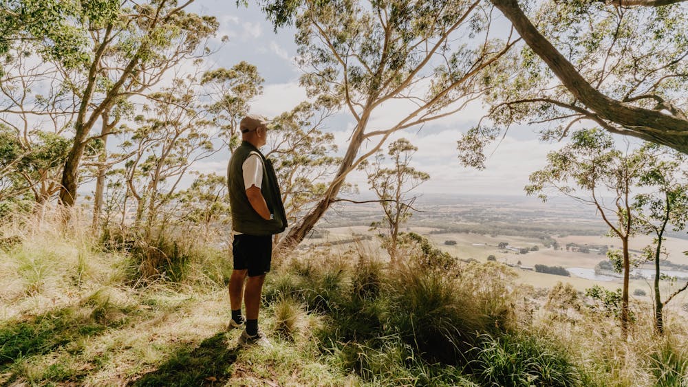 Person in bushland look out over Mt Buninyong