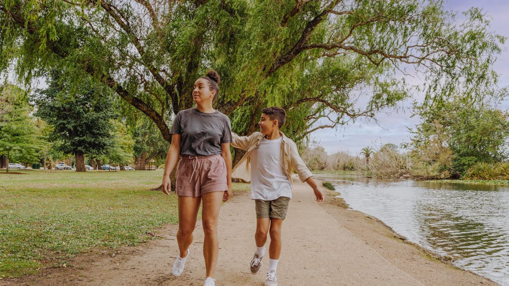 Adult women with child walking around Lake Wendouree pathway