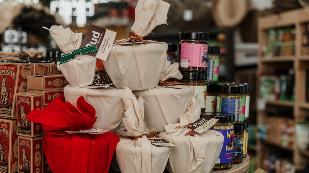 A stack of fabric-wrapped small Christmas puddings.