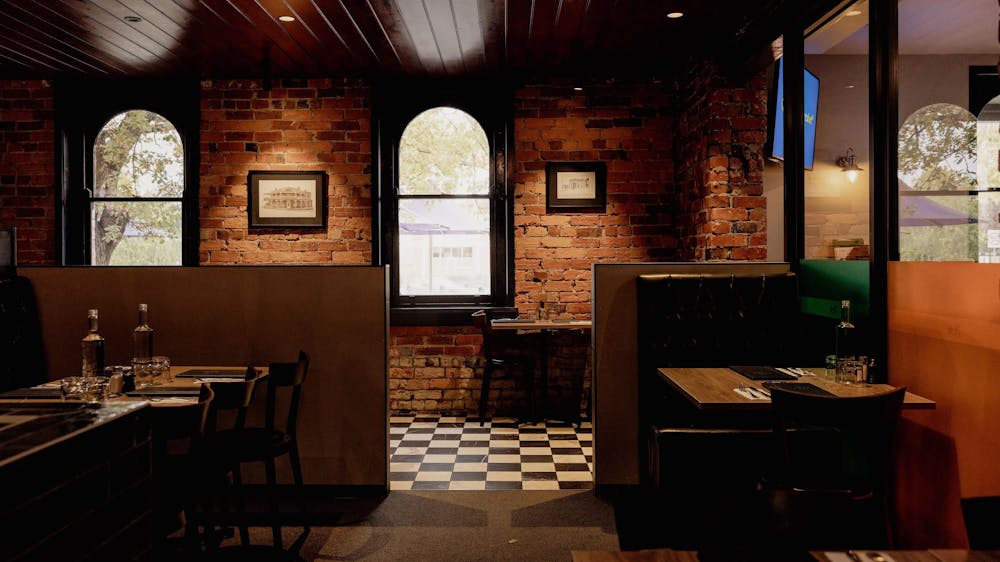Dining booths inside The North Star Hotel with exposed brick walls and heritage windows.