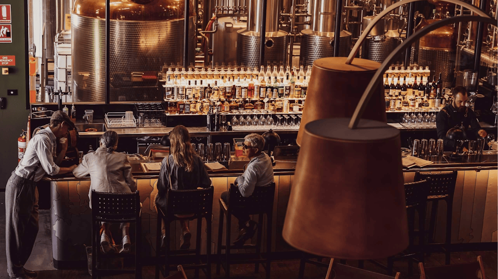 Four people seated at the bar