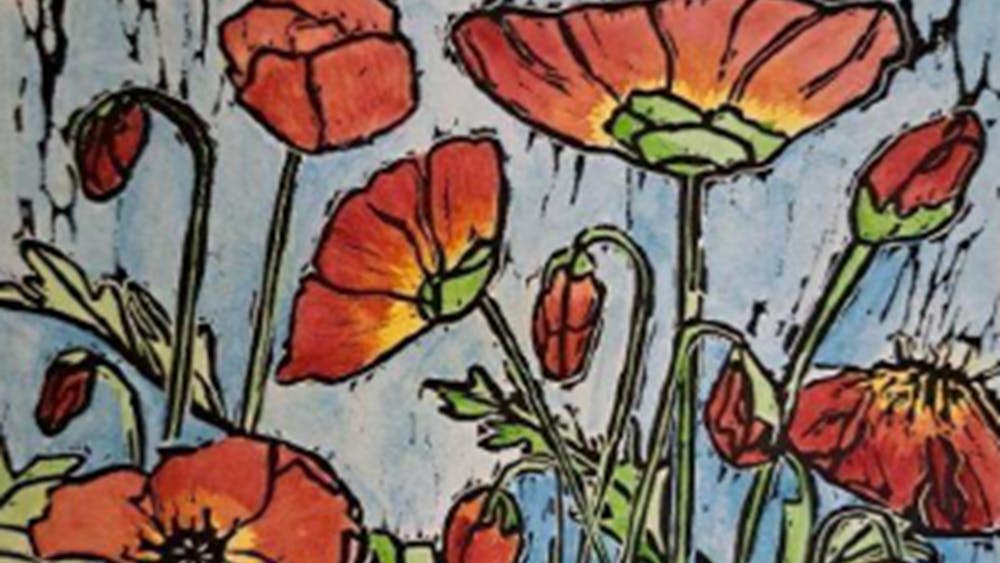 Blue background with orange red poppies in the foreground