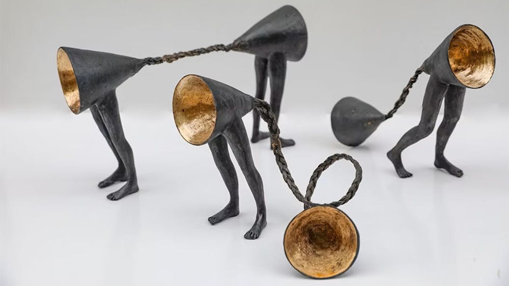 Bronze with gold leaf and hair.