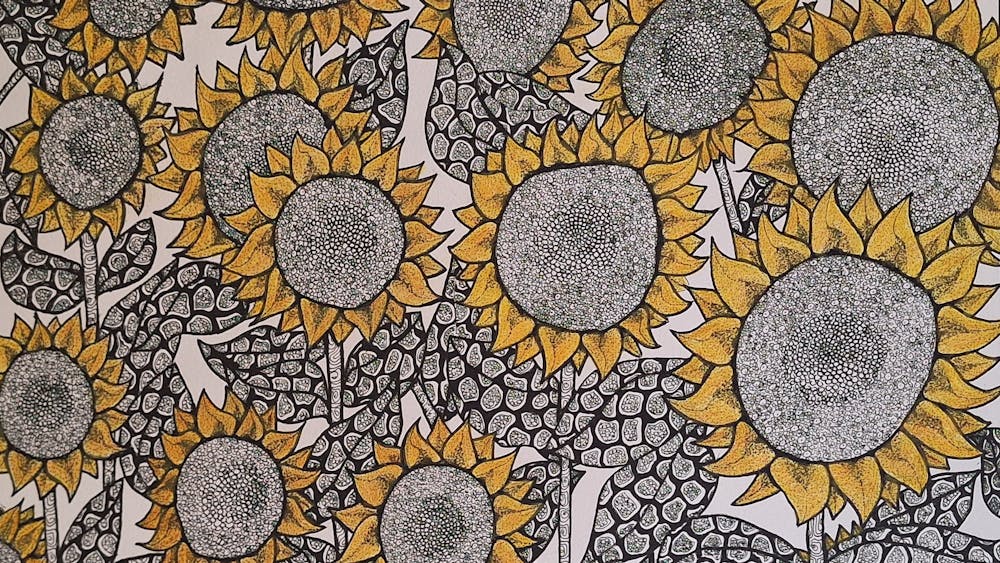 Multitude of sunflowers with patterned detail in black pen with yellow watercolour