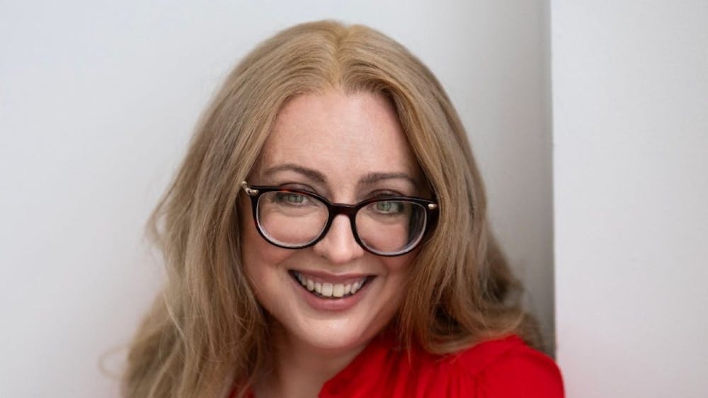 a lady facing the camera and smiling