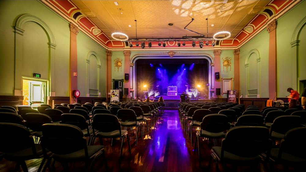 Interior of the Ballarat Mechanics Institute theatre, with rows of seating facing the stage.
