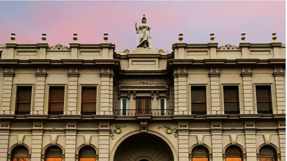 The historic façade of Ballarat Mechanics Institute in central Ballarat, lit warmly at dusk.