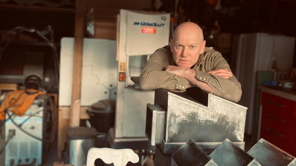 Cameron Ross in his studio with his sculptures