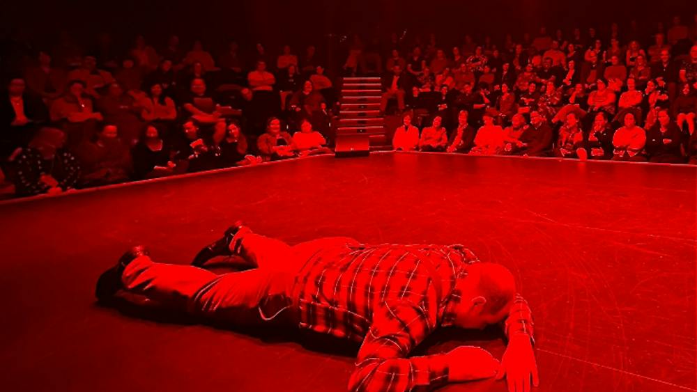 Actor lying facedown on the floor