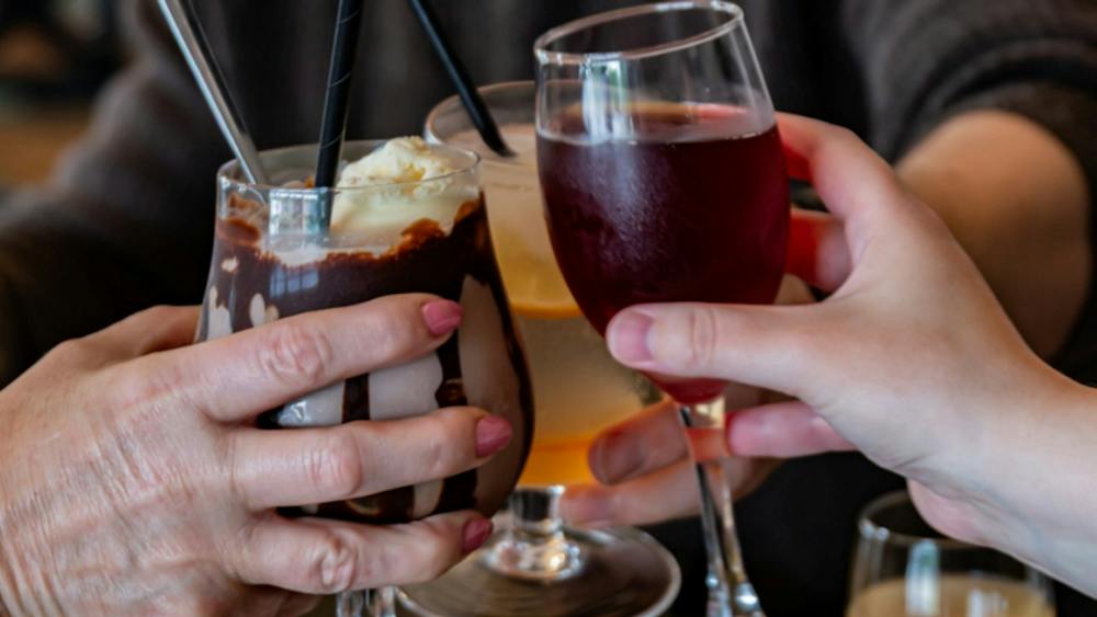 Three drinks are being toasted