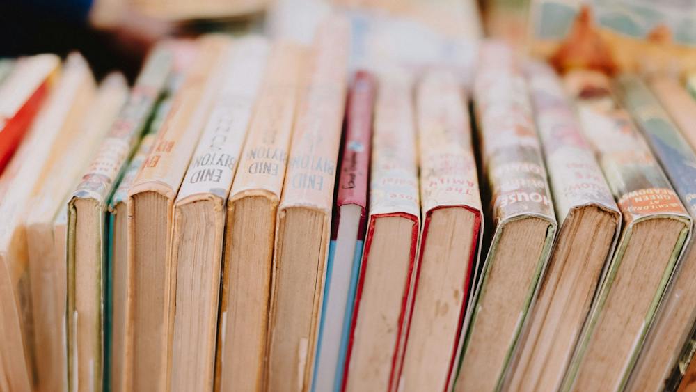 A stacks of books, lined up next to each other.