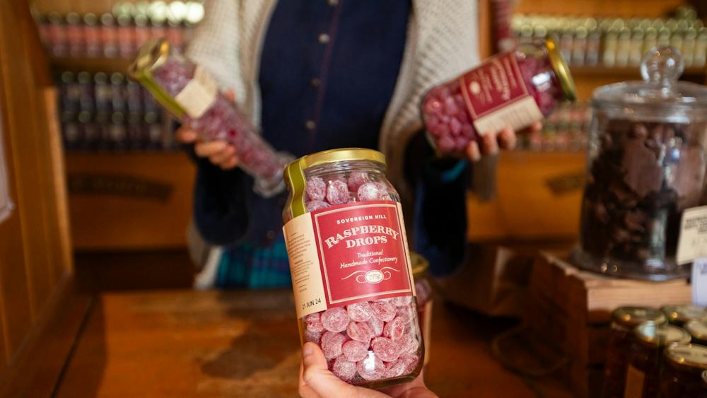 Hand holding jar of Raspberry Drops