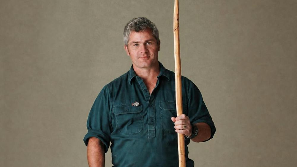 Man holding a wooden bow