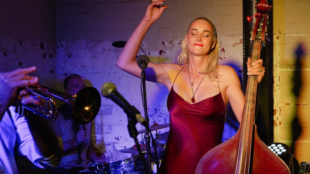 Female double bass player in red dress