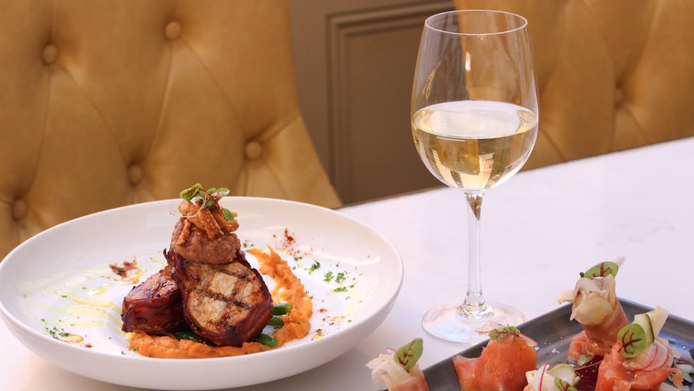 A dish and glass of wine placed at the table