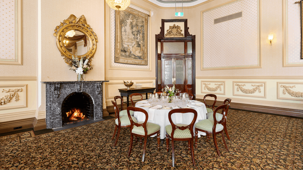 Craigs Royal Hotel interiors with a fireplace and a round table with chairs