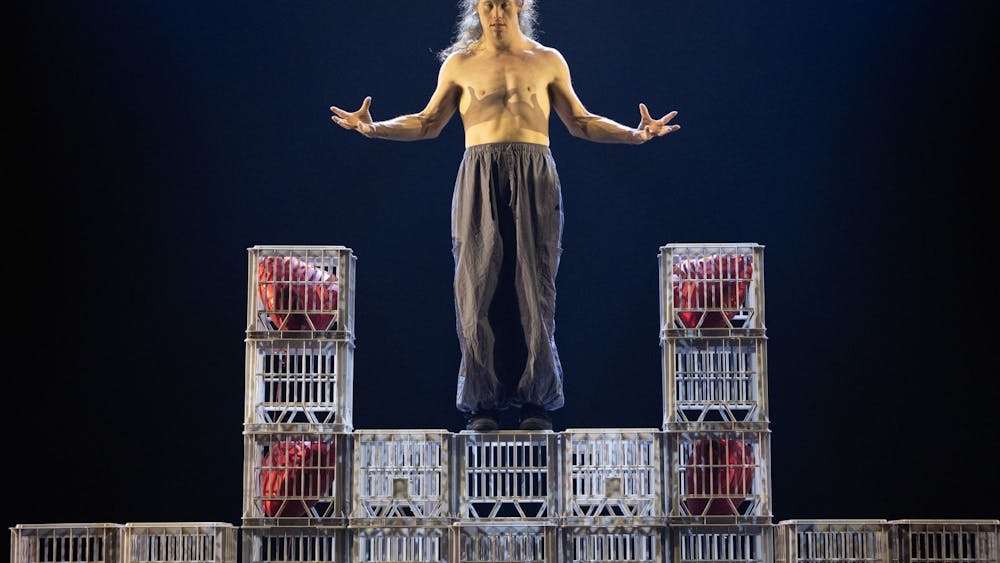 Chris Dyke without a shirt standing on milk crates