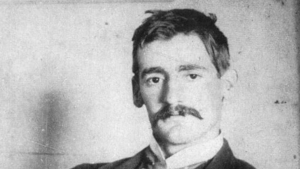 portrait of subject Henry Lawson seated