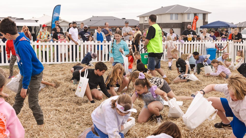 Children searching through straw to find Easter Eggs at the Hunt